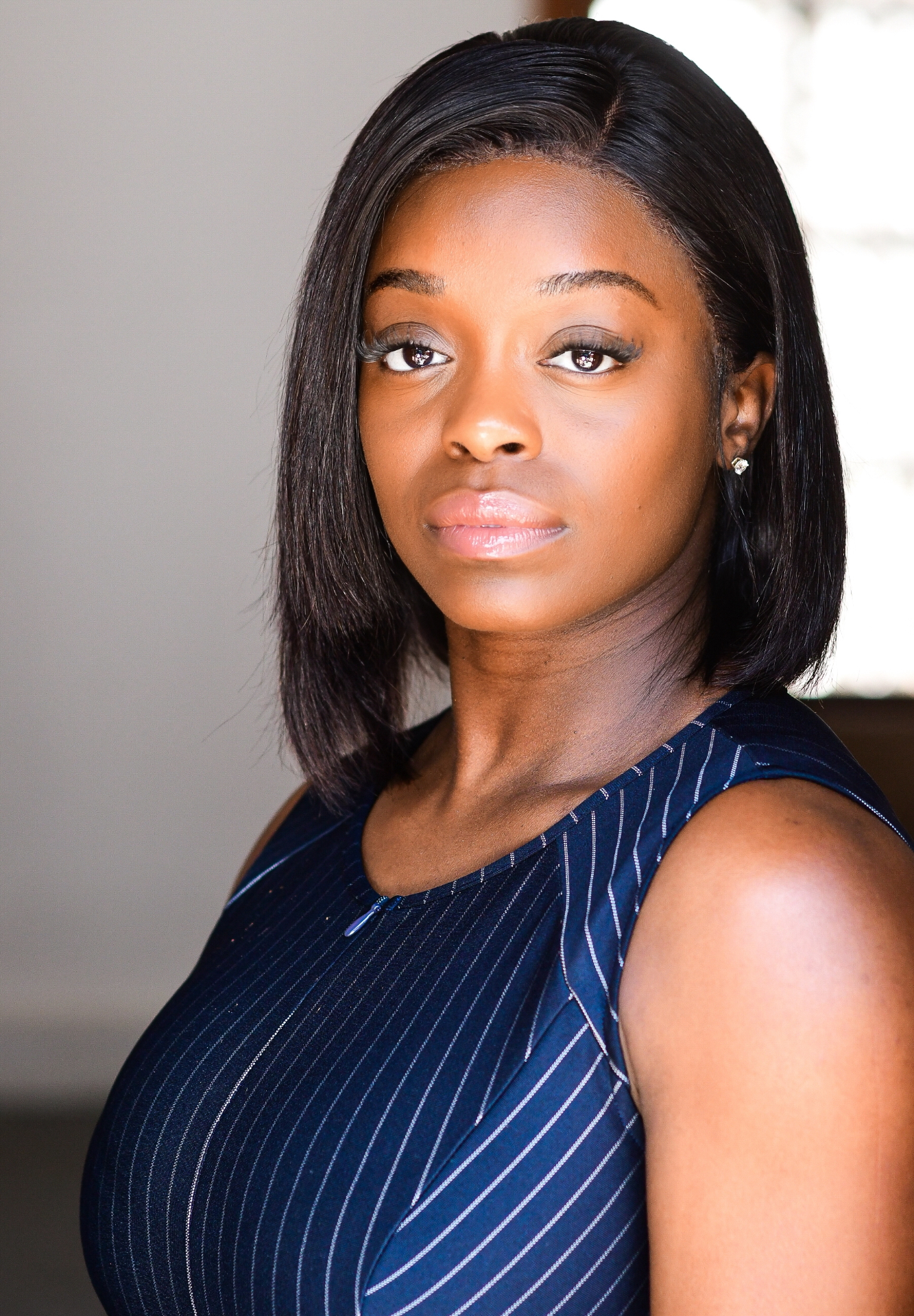 Professional headshot — navy pinstripe